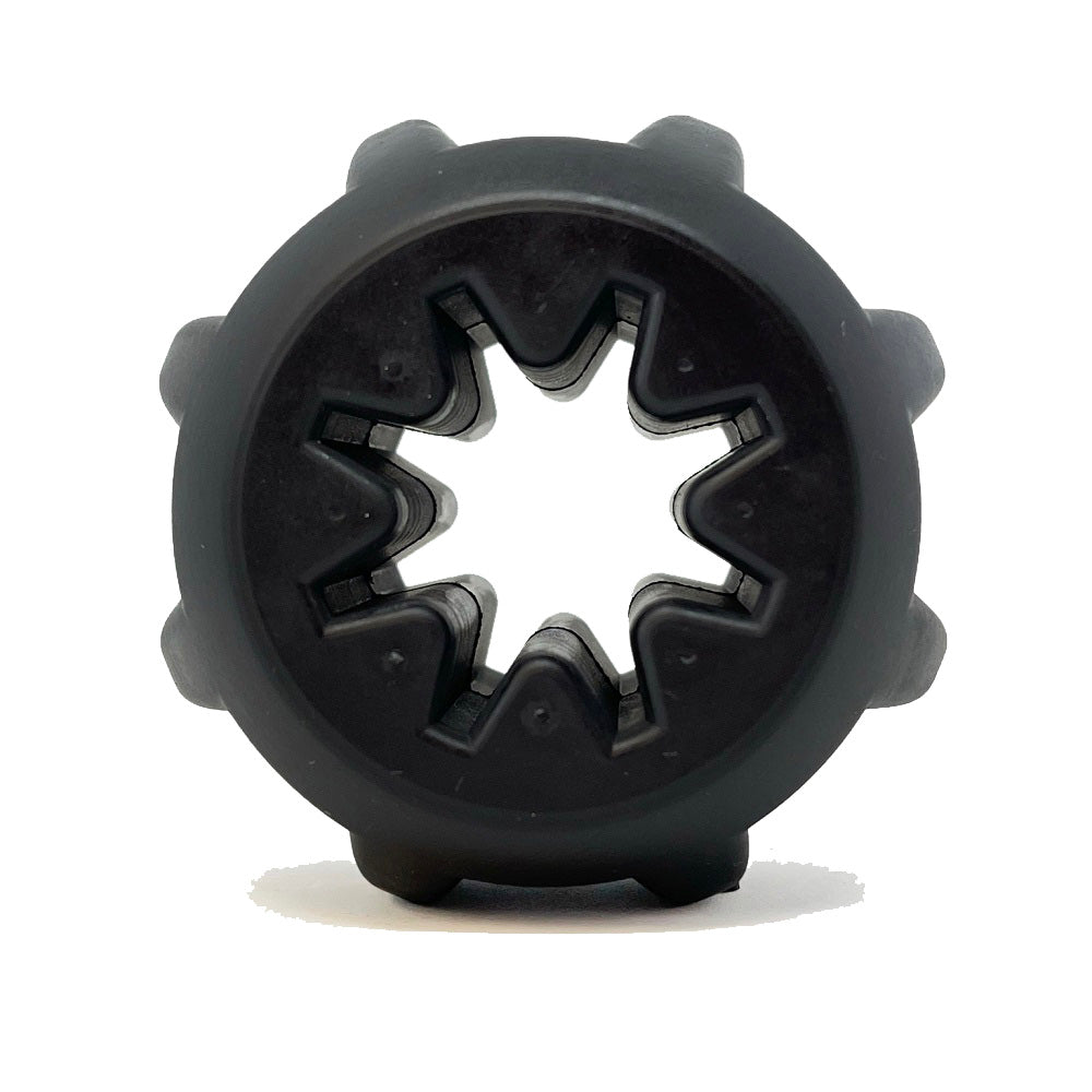 The Gear EDispener by SodaPup is a durable black rubber treat holder and chew toy with a star-shaped hollow center, rounded protrusions, and dental ridges for grip. Ideal for yak chews or power chewers, it resembles a coupler against a white background.