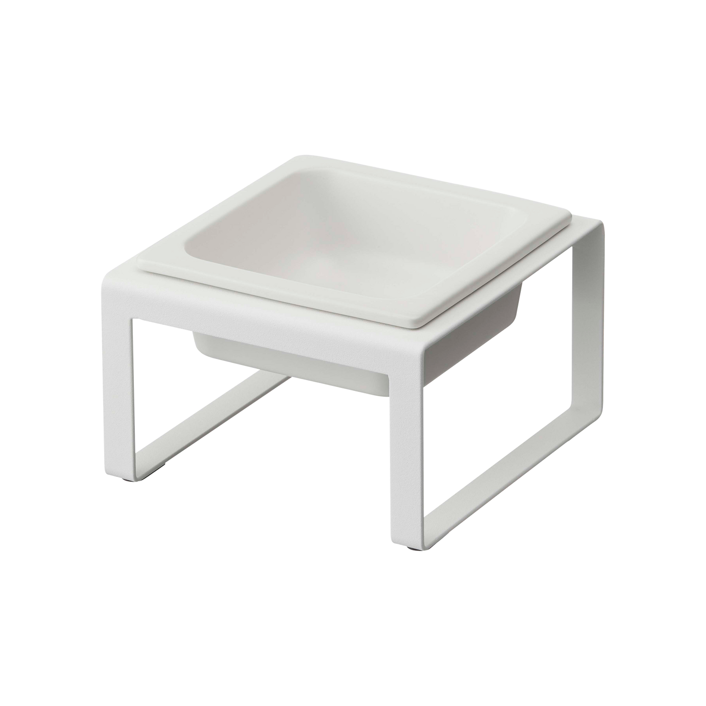 The Single Pet Food Bowl by Yamazaki Home showcases a white square dish, elegantly elevated on a minimalist frame with an open geometric design for a modern and sleek appearance. Constructed from steel and ceramic, this bowl is empty and clean, making it ideal for serving or display.