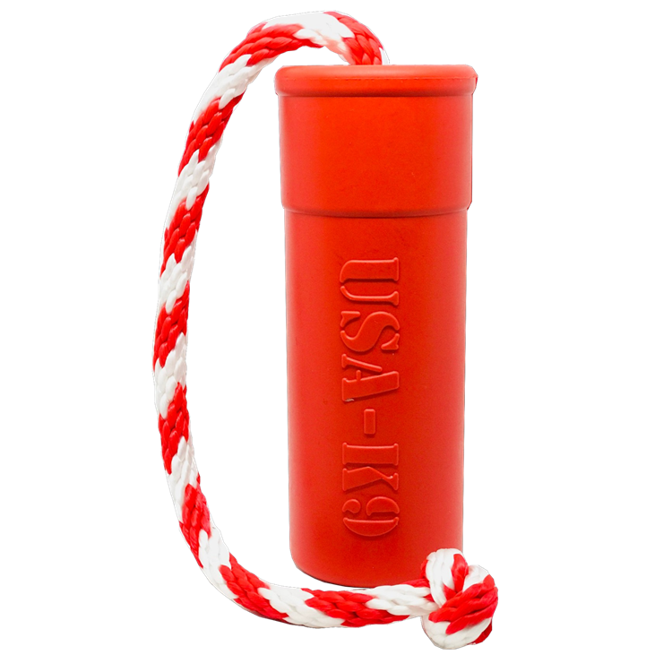 The SodaPup USA-K9 Firecracker Durable Rubber Floating Training Dummy in large red features a cylindrical shape with "USA-K9" embossing, attached to a red and white braided rope—ideal for interactive water fetch and play.