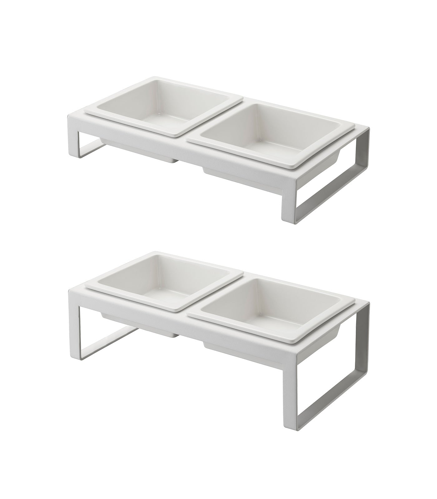 Two Yamazaki Home white double pet feeding stations with elevated stands hold two square bowls each. The minimalist, sleek rectangular design allows bowls to sit side by side and work with replacement ceramic bowls.