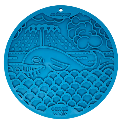 The SodaPup Whale Design EMat Enrichment Lick Mat With Suction Cups is a round blue silicone dog mat with a raised whale, waves, clouds, and sun design. "ematt whale" is embossed on the bottom. Perfect for bath time or enrichment.