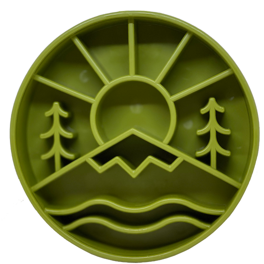 The Great Outdoors Design eBowl Enrichment Slow Feeder Bowl for Dogs by SodaPup, in a green round mold, showcases a scenic design with a sun, two trees, mountains, and wavy lines that resemble water.