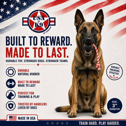 A Belgian Malinois holds the SodaPup USA-K9 Magnum Black Stars and Stripes Ultra-Durable Rubber Chew Toy in its mouth. Made in the USA for power chewers, this durable reward, tug, and retrieving toy features a patriotic design.