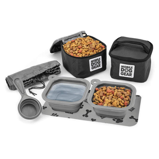 A Mobile Dog Gear Dine Away® Food Set, Small, Black including a large black food storage bag, two smaller food containers with lids, a collapsible bowl, and a gray feeding mat.