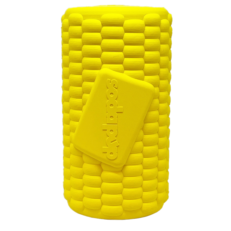 The SodaPup Corn on the Cob EDispenser is a durable, bright yellow dog chew toy and treat dispenser with a bumpy, kernel-like surface and "sodapop" embossed on its attached rectangular piece.