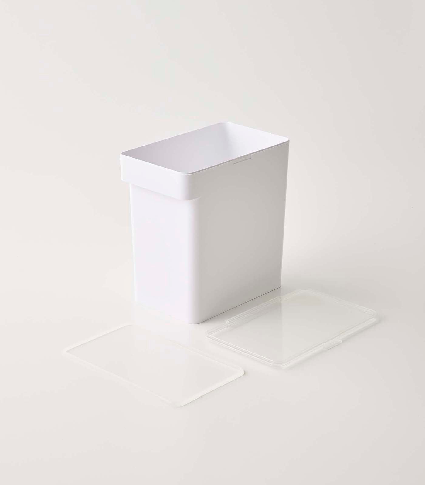 A minimalistic white rectangular Yamazaki Home airtight pet food container with its lid off, set against a plain light background, accompanied by a clear plastic liner on the side.