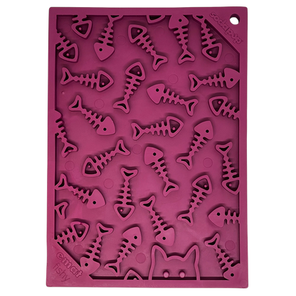 The SodaPup Fishy Design EMat Enrichment Lick Mat - Small is a purple silicone mat with raised fish, fishbone shapes, and a partial cat face outline—perfect for serving pet treats or as an engaging feeding surface.