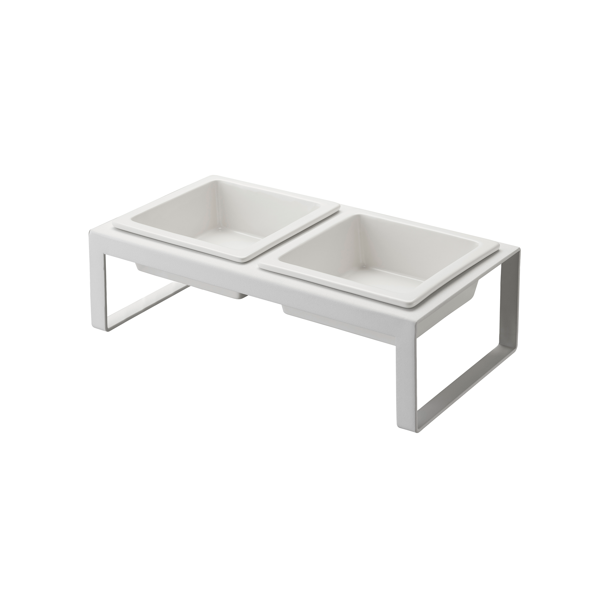 The Pet Food Bowl by Yamazaki Home is a white, elevated feeding station that includes two square ceramic bowls. Its minimalist frame provides a modern look and is designed to keep the bowls at a comfortable height for pets.