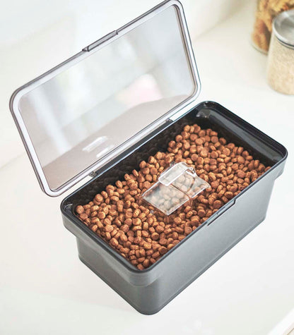 An Airtight Pet Food Container - Three Sizes - Polypropylene by Yamazaki Home filled with kibble.