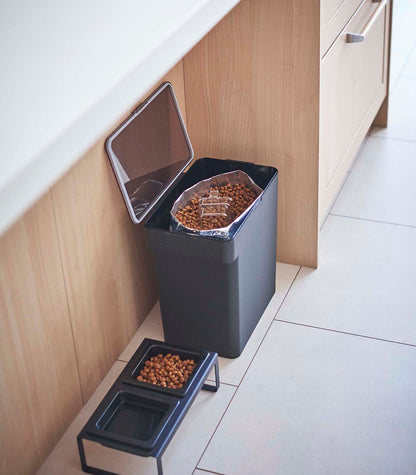 A kitchen with a Yamazaki Home Airtight Pet Food Container - Three Sizes on the floor.