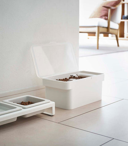 An Airtight Pet Food Container - Three Sizes by Yamazaki Home on the floor with kibble.