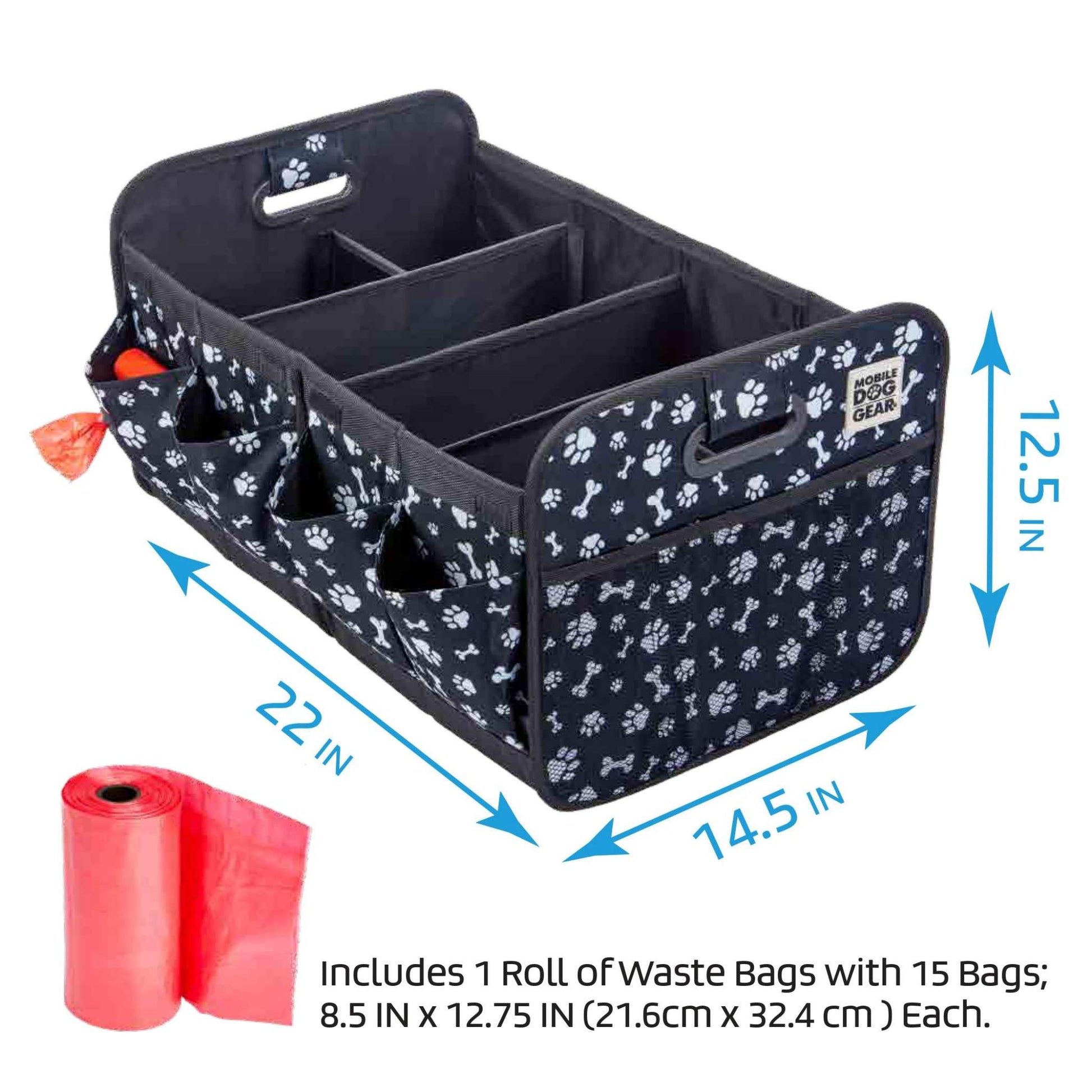 A black Mobile Dog Gear Dogssentials Collapsible Storage Organizer with white paw prints, dimensions of 22"x14.5"x12.5", featuring four sections and pockets, including a built-in waste bag dispenser with a roll of red waste bags. Text reads: "Includes 1 Roll of Waste Bags with 15 Bags; 8.5 IN x 12.75 IN (21.6cm x 32).