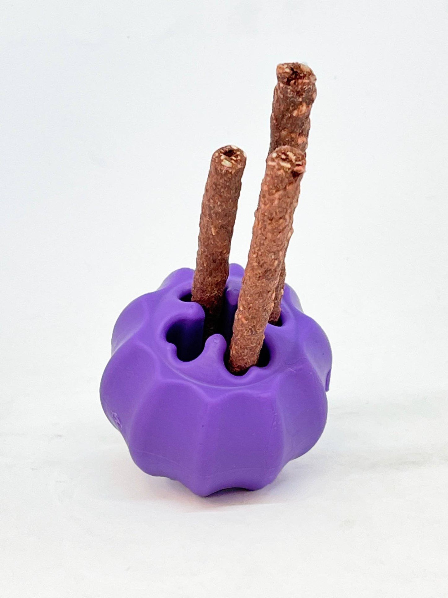 A durable Cross Bones Chew Toy and Treat Pocket with three sticks for treats dispensing made by SodaPup.