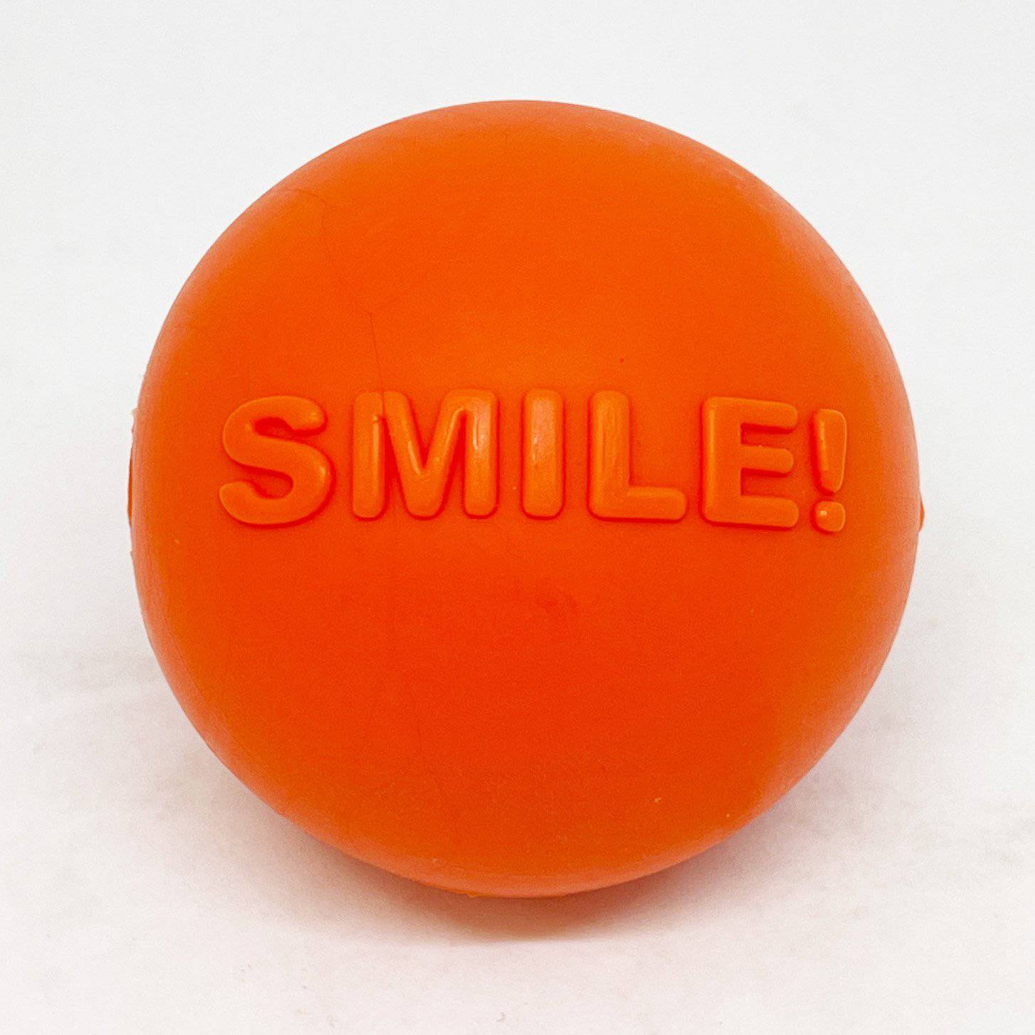 An orange Smile Ball Ultra Durable Synthetic Rubber Chew Toy & Floating Retrieving Toy from SodaPup.