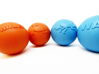 A group of SodaPup Smile Ball Ultra Durable Synthetic Rubber Chew Toy & Floating Retrieving Toy for power-chewers.