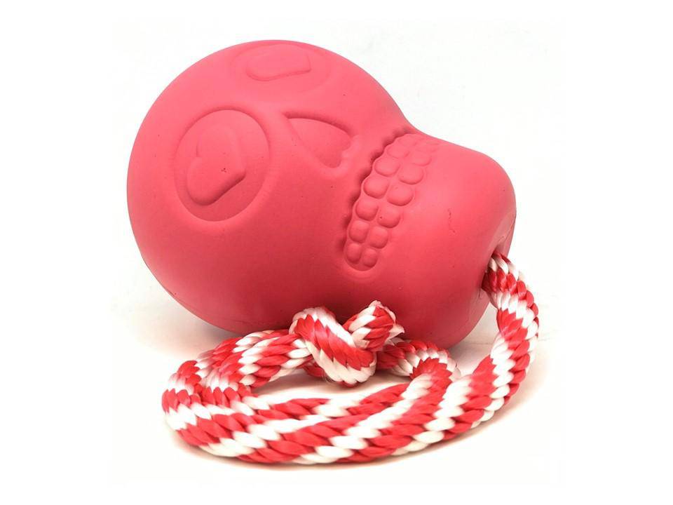 A SodaPup USA-K9 Skull Durable Rubber Chew Toy, Treat Dispenser, Reward Toy, Tug Toy, and Retrieving Toy - Pink.