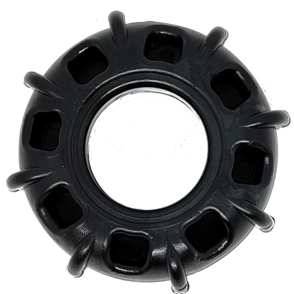 The SodaPup ID Tractor Tire EChew Ultra Durable Nylon Chew & Enrichment Toy is a black, circular tire-shaped dog toy with a hollow center and rectangular holes, shown from above on a white background.