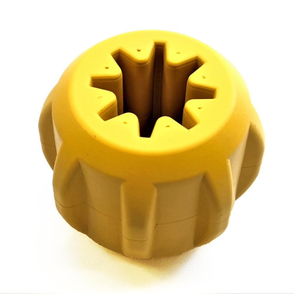 A yellow, round plastic object with a star-shaped opening at its center closely resembles the Gear EDispener Durable Rubber Treat Holder and Chew Toy by SodaPup, crafted to endure even the most determined power chewer. Set against a plain white background, it features dental ridges for added functionality.