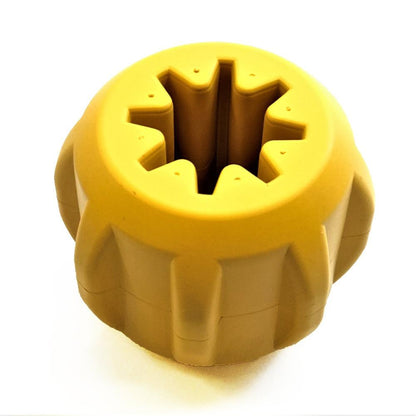 A yellow, round plastic object with a star-shaped opening at its center closely resembles the Gear EDispener Durable Rubber Treat Holder and Chew Toy by SodaPup, crafted to endure even the most determined power chewer. Set against a plain white background, it features dental ridges for added functionality.