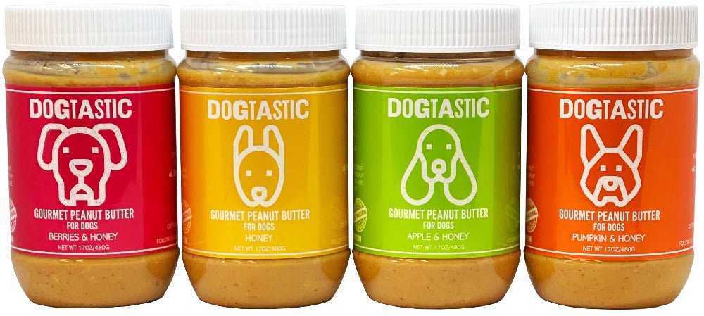 Four jars of SodaPup Dogtastic Gourmet Peanut Butter for Dogs - Berries & Honey Flavor in different colors.