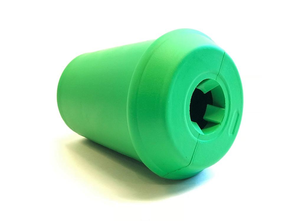 A green, cylindrical SodaPup Coffee Cup EDispener, crafted from durable rubber and featuring a rounded, ridged top with a hollow center resembling a slow feeder toy. Resting on its side, the surface appears smooth with a subtle sheen.