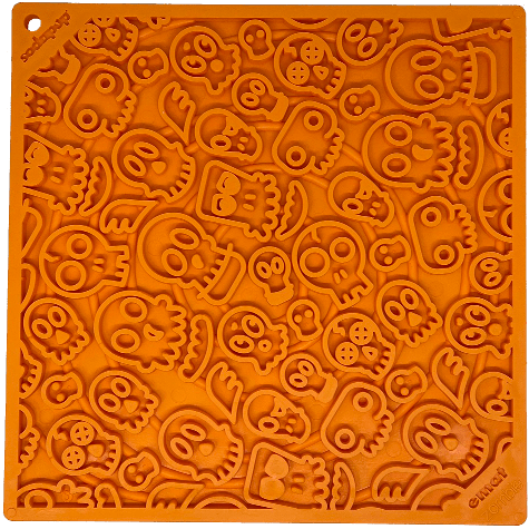 A large orange Zombie Design Emat Enrichment Lick Mat with skulls on it, perfect for dog enrichment and calming mat activities by SodaPup.
