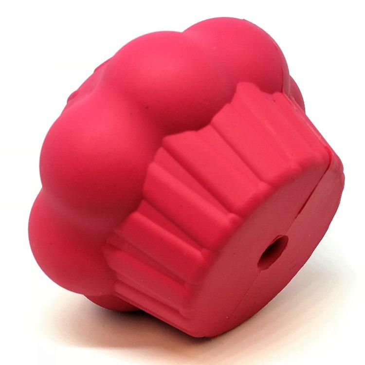 Introducing the Cupcake EDispenser from SodaPup—a durable red rubber chew toy featuring a round, scalloped edge and textured grip. This innovative design includes a central hole, resembling a gear or mechanical part, which cleverly dispenses treats while serving as an engaging slow feeder for your pet.