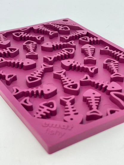 A pink ice tray with a pattern of fish on it, perfect for creating treats or enriching your pet's mealtime with a Fishy Design EMat Enrichment Lick Mat - Small by SodaPup.