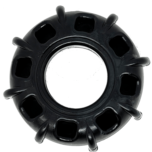 A black SodaPup Tractor Tire Ultra Durable Nylon Chew & Enrichment Toy, an enrichment toy for power chewers.