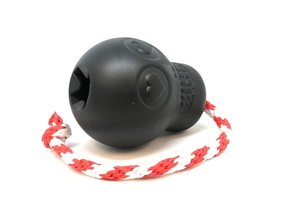 A SodaPup USA-K9 Magnum Skull Durable Rubber Chew Toy, Treat Dispenser, Reward Toy, Tug Toy, and Retrieving Toy - Black Magnum with a rope attached to it.