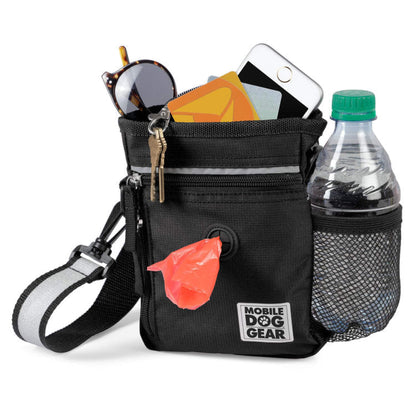 A Day or Night Walking Bag by Mobile Dog Gear with a bottle, sunglasses, and other items for dog walking at night.