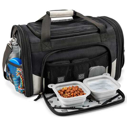 A Mobile Dog Gear Pet Carrier Plus in black, packed with a water bottle, snacks, and a lunch box with food, showcasing its mobile dog gear storage capacity and organization features.