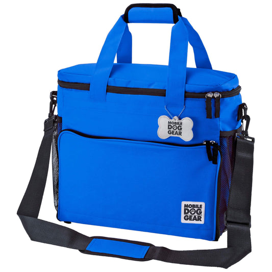 A bright blue Mobile Dog Gear Large Week Away® Tote Bag with multiple compartments and zippers, featuring sturdy carrying handles and an adjustable shoulder strap.