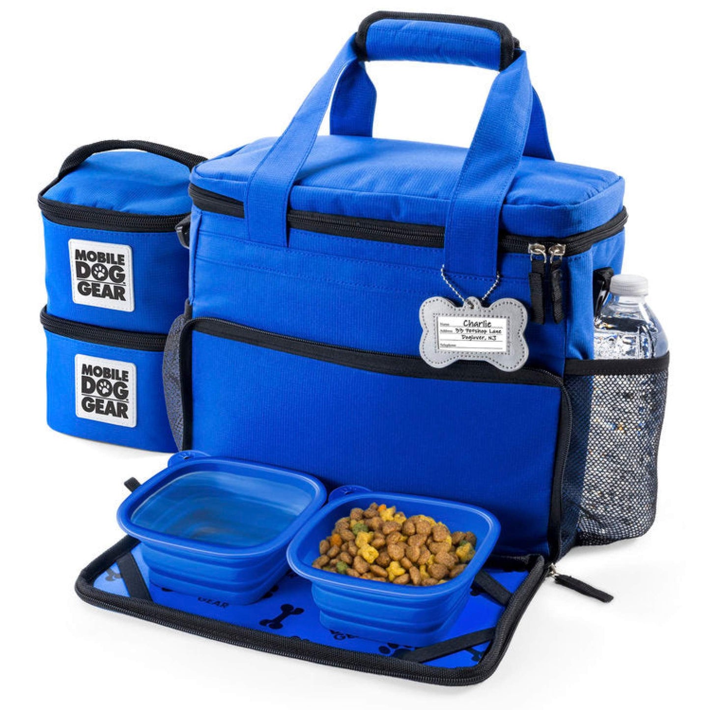 A blue Small Week Away® Tote Bag set for dogs, featuring multiple compartments, collapsible dog bowls, and food containers filled with kibble and water. Each item is labeled "Mobile Dog Gear.