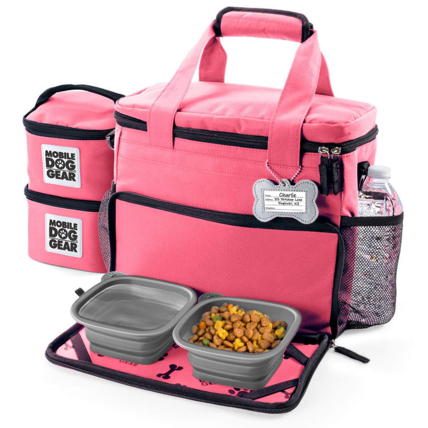 Pink Small Week Away® Tote Bag with a detachable side pouch, a water bottle holder, and two collapsible dog bowls filled with dog food, displayed on an integrated feeding mat by Mobile Dog Gear.