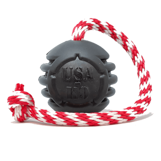 A SodaPup Magnum Black Stars and Stripes Ultra-Durable Rubber Chew Toy, Reward Toy, Tug Toy, and Retrieving Toy - Black with dental ridges.