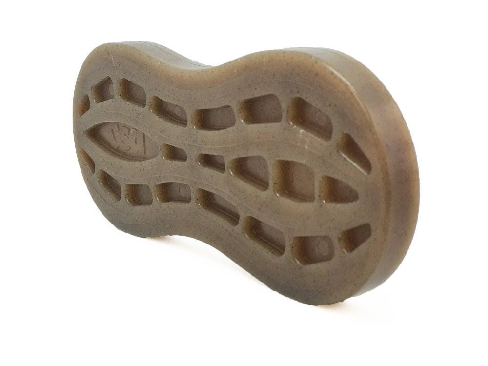 The Peanut EChew Ultra Durable Nylon Dog Chew Toy from SodaPup boasts a translucent brown design featuring a textured pattern with rectangular grooves and a wavy finish. Displayed at an angle that highlights its contours and tread, this product is perfect for style-conscious power chewers.