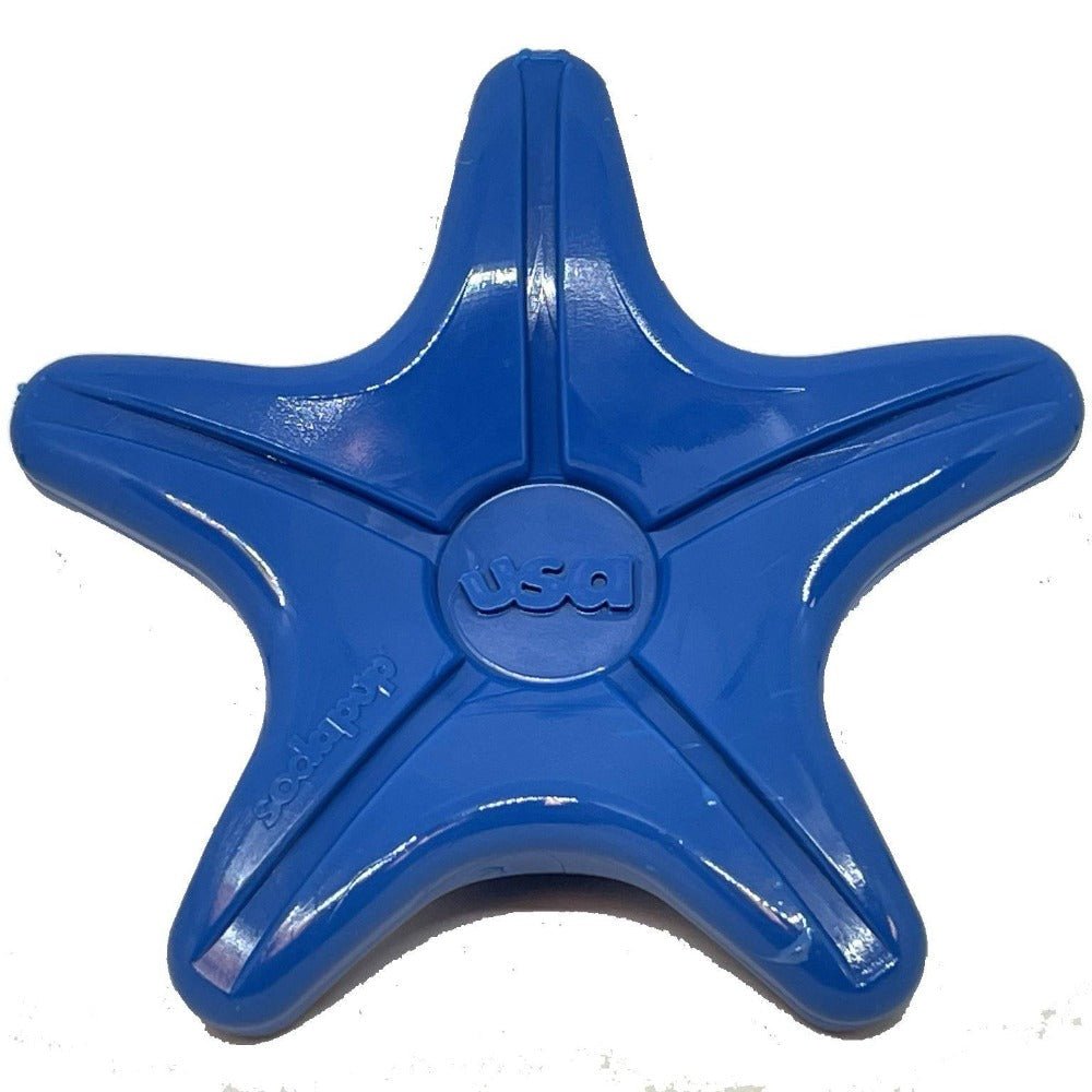 A durable SodaPup Starfish Ultra Durable Nylon Dog Chew Toy for Aggressive Chewers on a white surface.