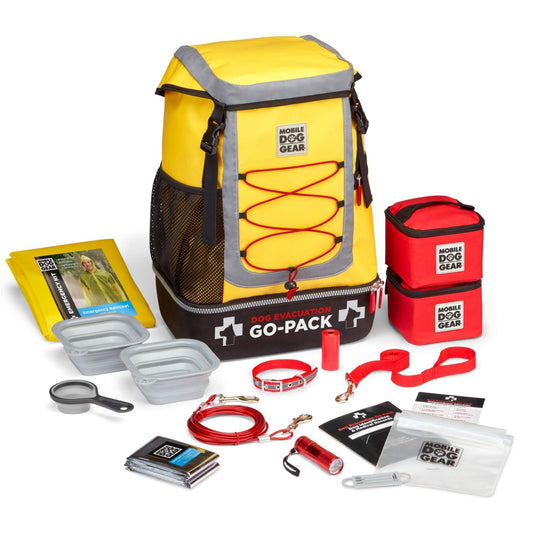 A yellow Mobile Dog Gear backpack with a variety of Dog Evacuation Go-Pack, Small essentials in it.